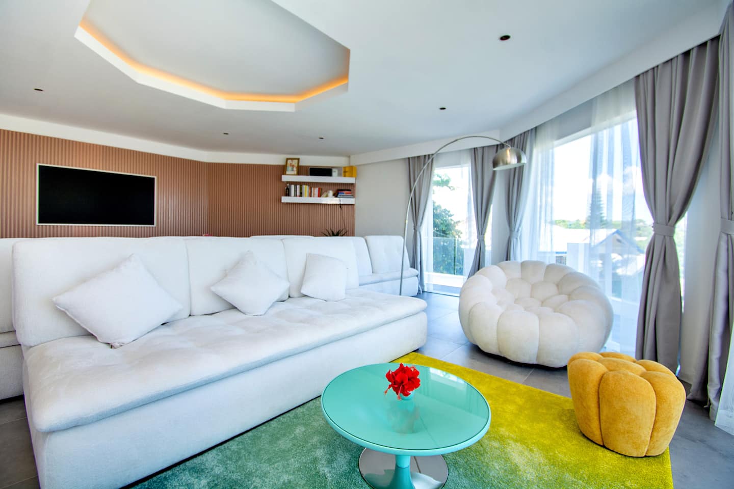 Open-plan living room with sofa and sea views