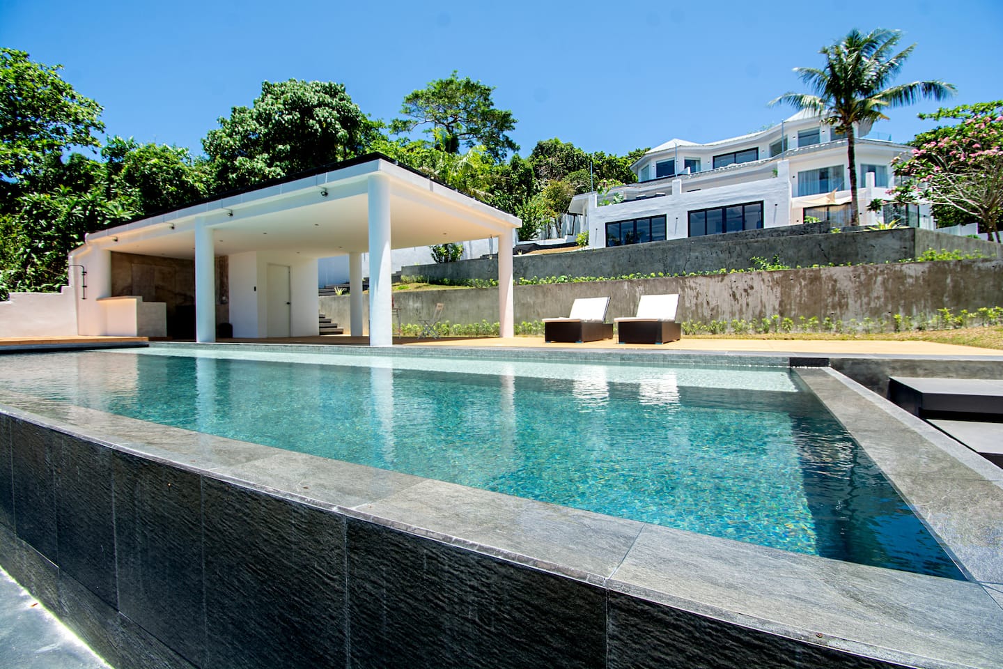 Pool with cabana and villa behind
